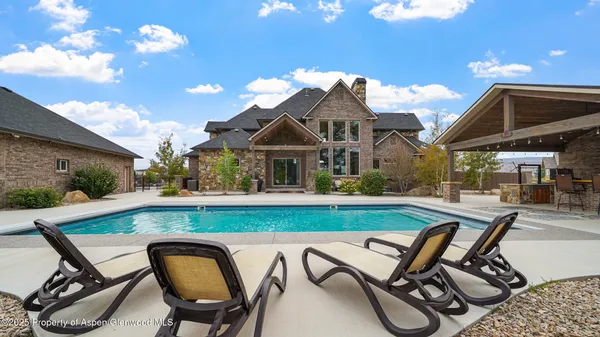 a view of swimming pool with lounge chair