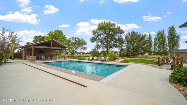 a view of a house with backyard porch and sitting area