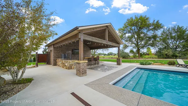 a view of a porch with a table and chairs