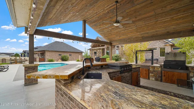 a view of a house with swimming pool and sitting area