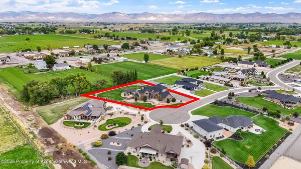 an aerial view of a house with garden space and street view