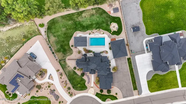 an aerial view of residential house with outdoor space pool patio and lake view