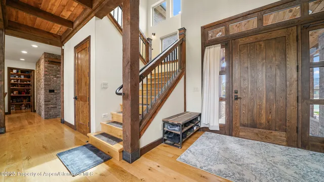 a view of a livingroom with furniture and staircase