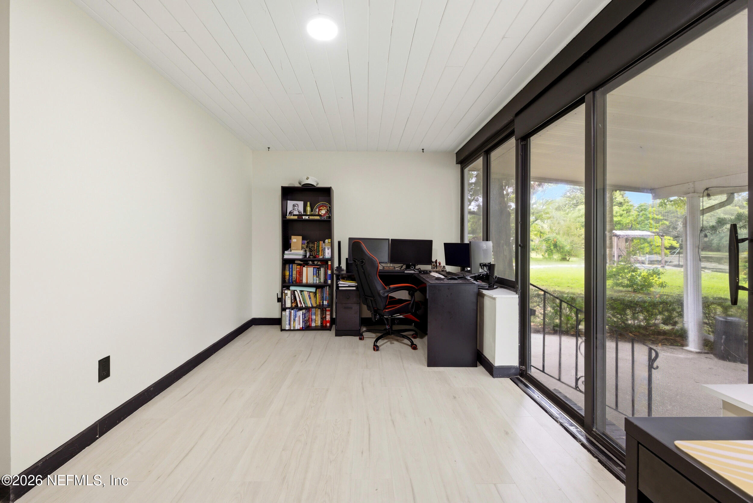 7484 Spinola Road Jacksonville, FL 32217 - Photo 45 of 63 a view of a workspace with furniture and a gate