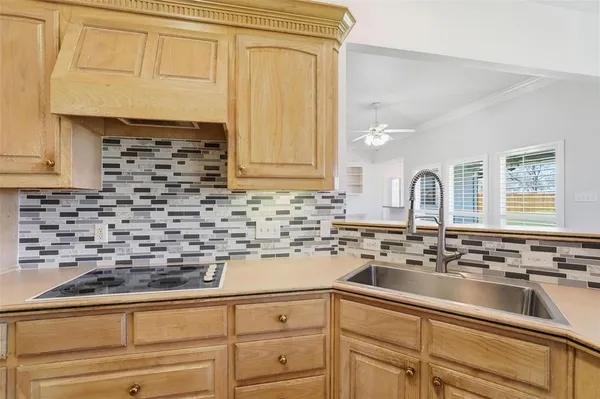 a kitchen with sink cabinets and window