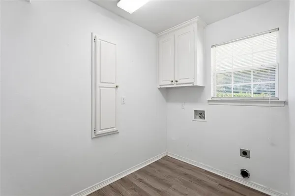 a view of small space with wooden floor and cabinet