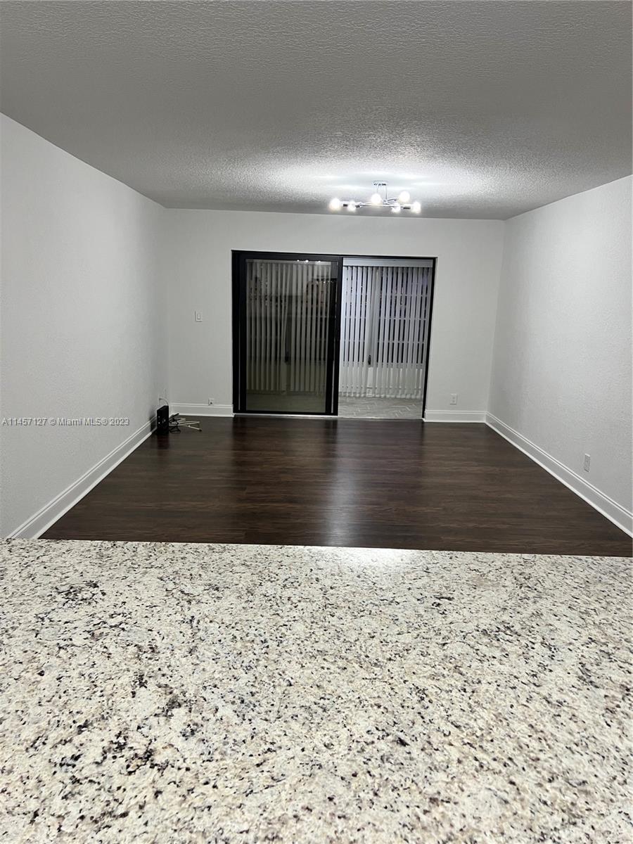 9355 Southwest 8th Street, Unit 124 Boca Raton, FL 33428 - Photo 5 of 23 wooden floor in a hall with an entryway