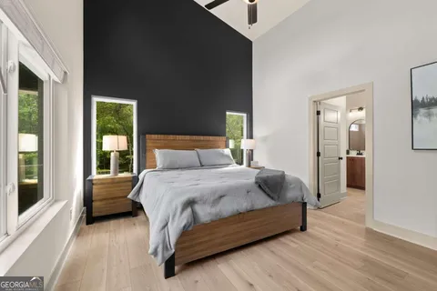 a bedroom with a bed and wooden floor