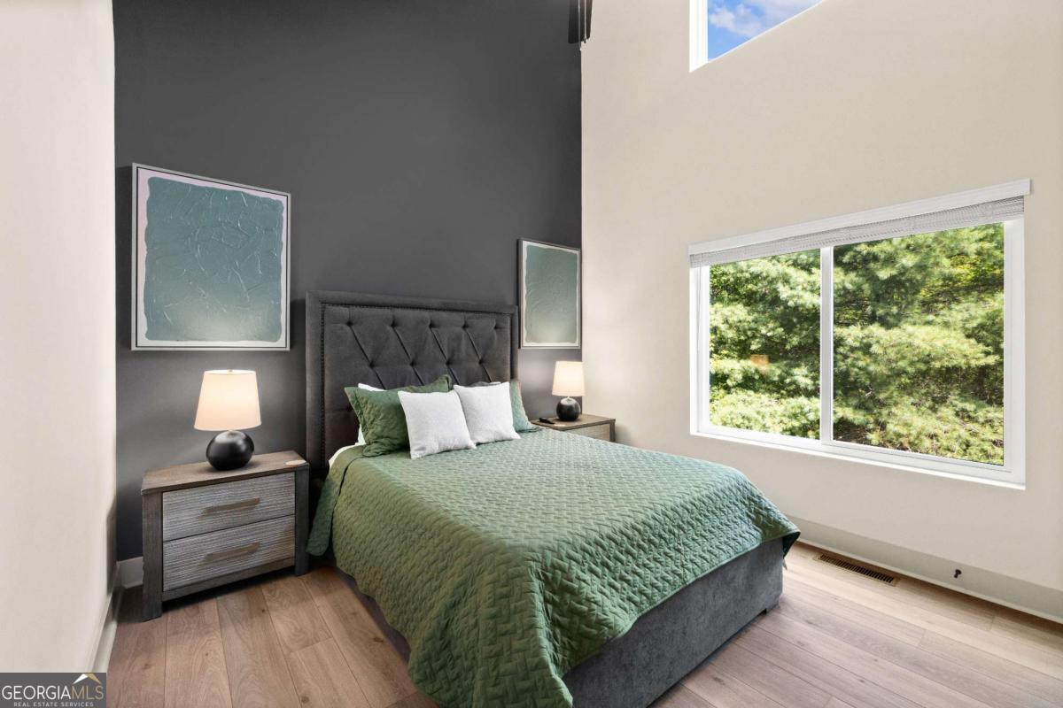 1421 Kelly Ridge Drive, Unit 28 Blue Ridge, GA 30513 - Photo 14 of 39 a large bed sitting in a bedroom next to a window