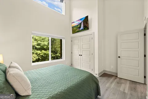 a bedroom with a bed and a window