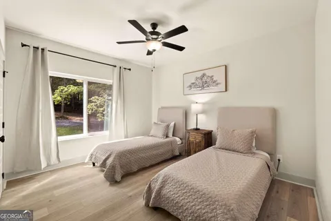 a bedroom with two beds and a large window