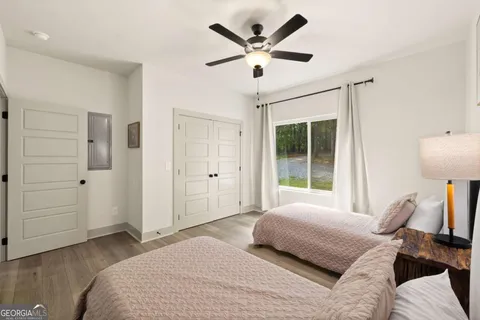 a bedroom with a large bed and a window