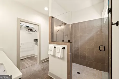 a bathroom with a shower a sink and a mirror