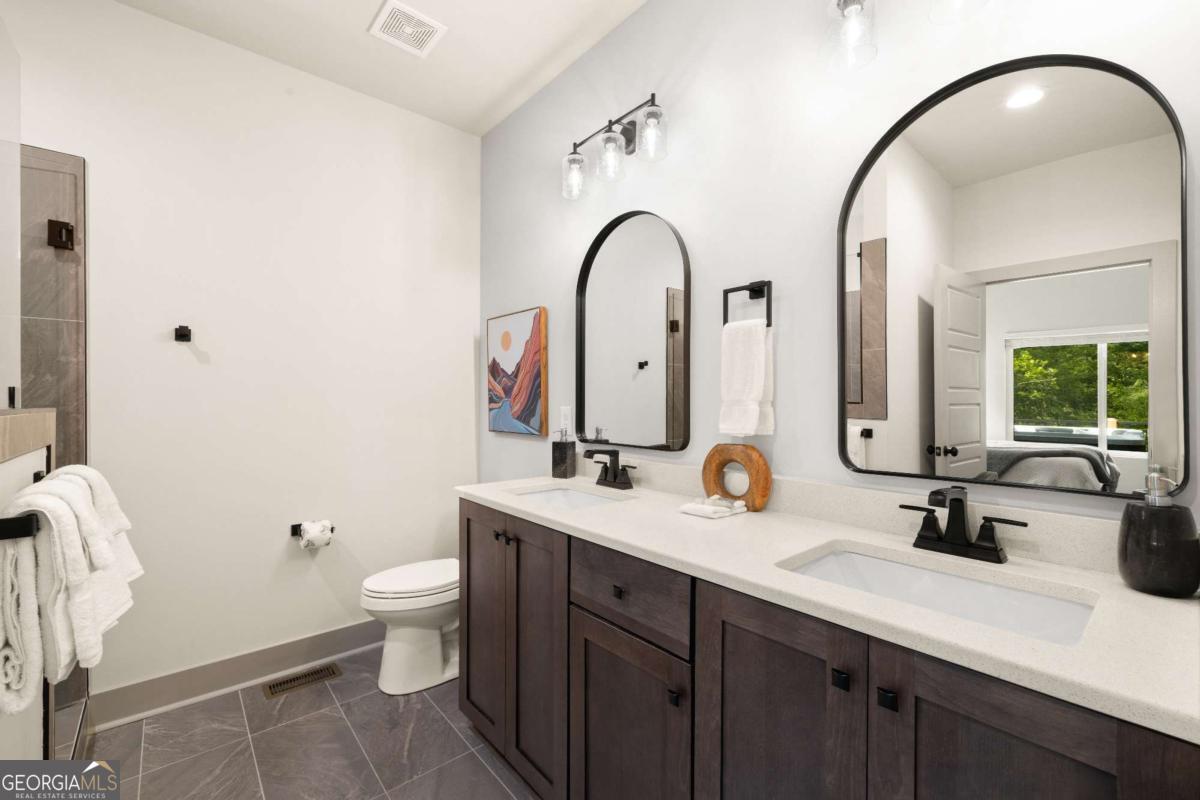 1421 Kelly Ridge Drive, Unit 28 Blue Ridge, GA 30513 - Photo 19 of 39 a bathroom with a double vanity sink mirror and toilet