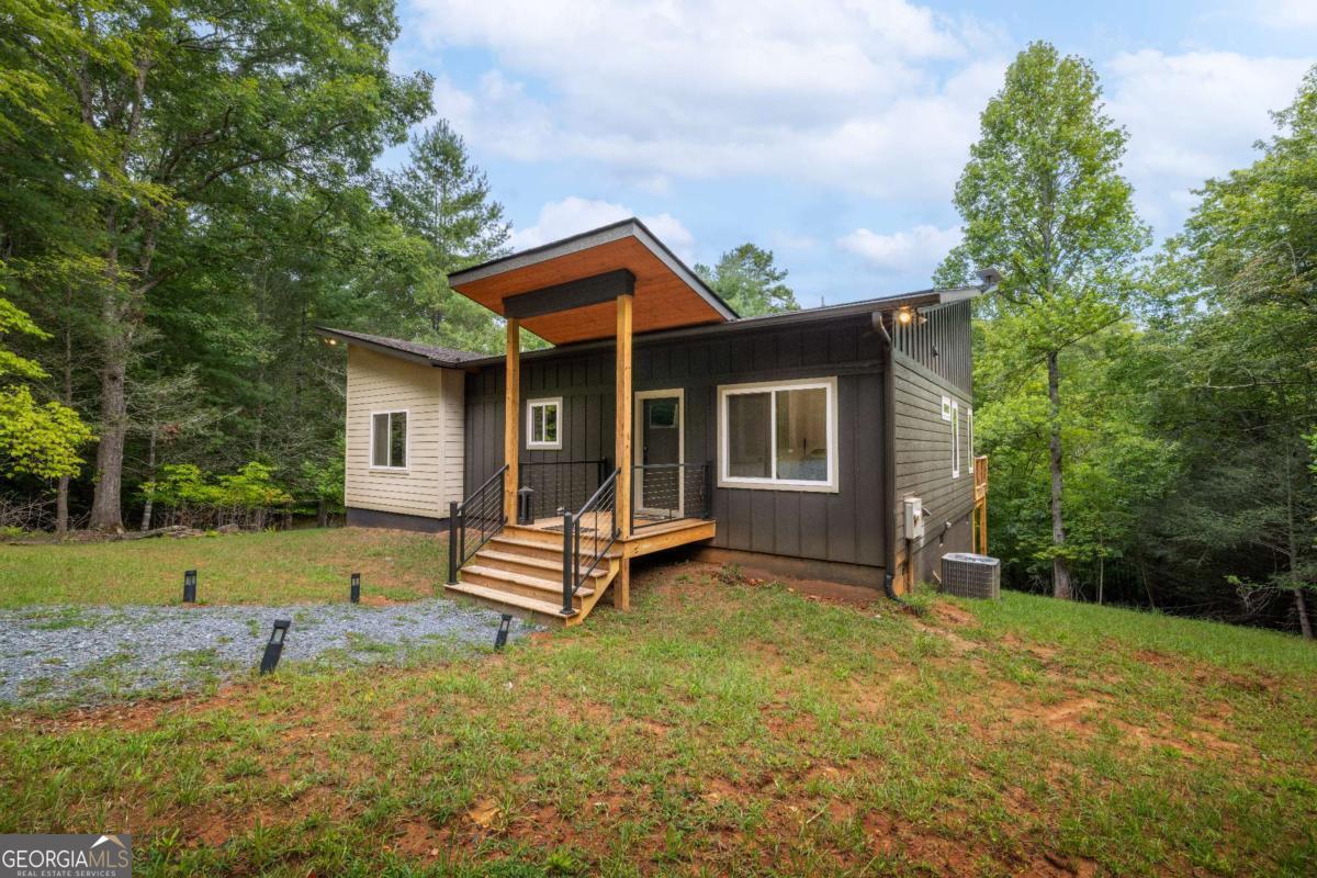 1421 Kelly Ridge Drive, Unit 28 Blue Ridge, GA 30513 - Photo 2 of 39 a front view of a house with a garden and yard