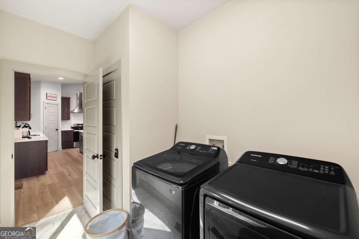 1421 Kelly Ridge Drive, Unit 28 Blue Ridge, GA 30513 - Photo 24 of 39 a view of an empty room and a kitchen with a stove