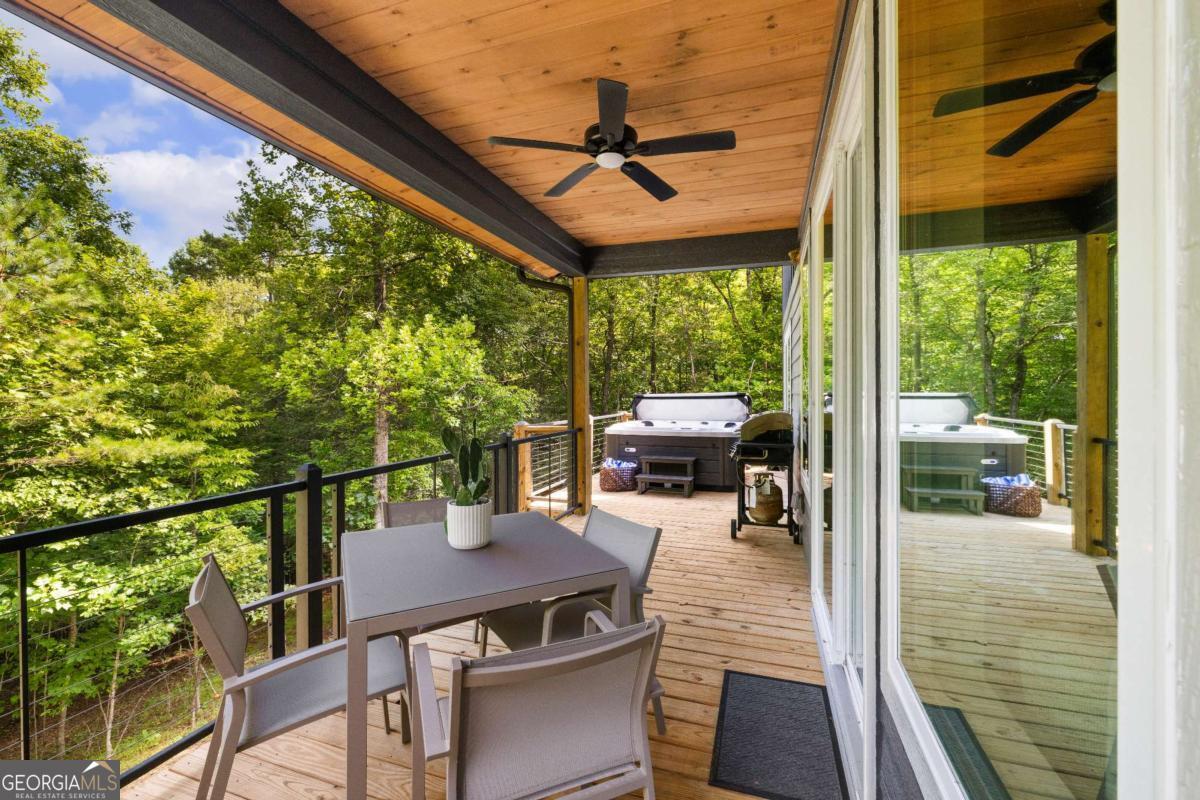 1421 Kelly Ridge Drive, Unit 28 Blue Ridge, GA 30513 - Photo 26 of 39 a view of a patio with a table chairs and a backyard