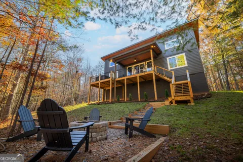a view of a house with swimming pool and sitting area