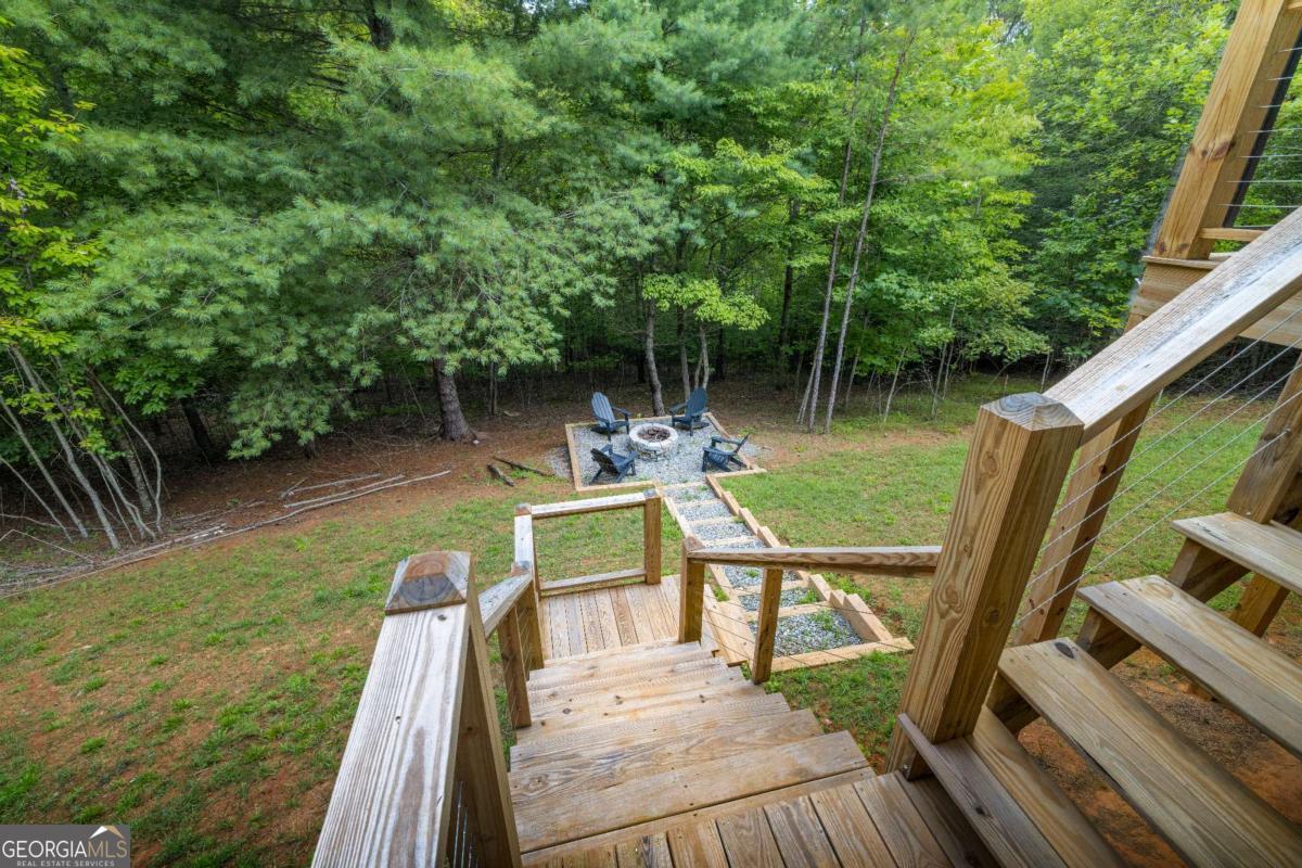 1421 Kelly Ridge Drive, Unit 28 Blue Ridge, GA 30513 - Photo 38 of 39 a view of a deck with chairs next to a yard
