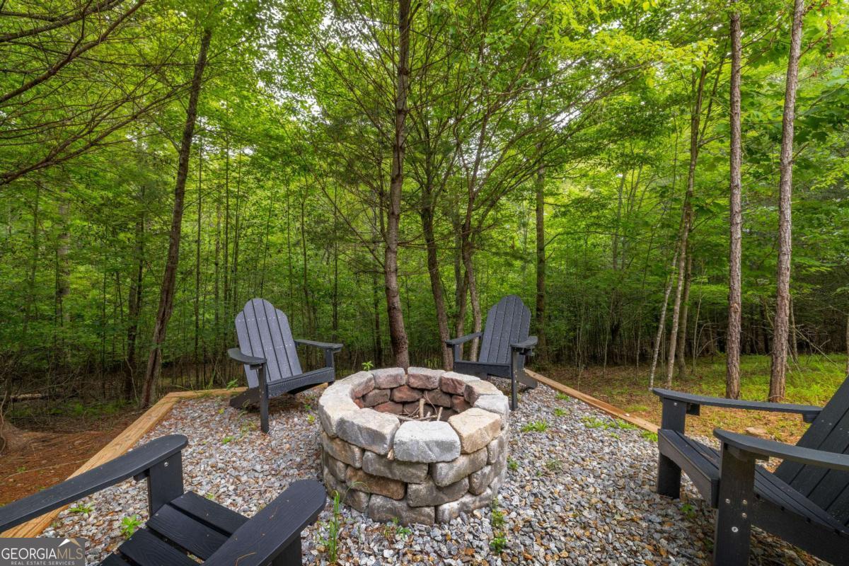 1421 Kelly Ridge Drive, Unit 28 Blue Ridge, GA 30513 - Photo 39 of 39 a view of a chair and tables in the balcony