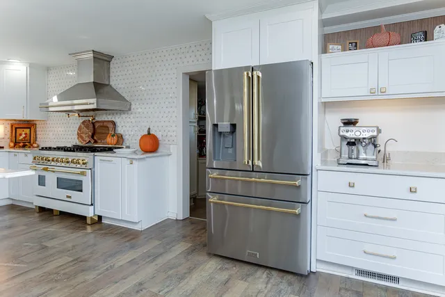 a kitchen with stainless steel appliances a refrigerator and cabinets