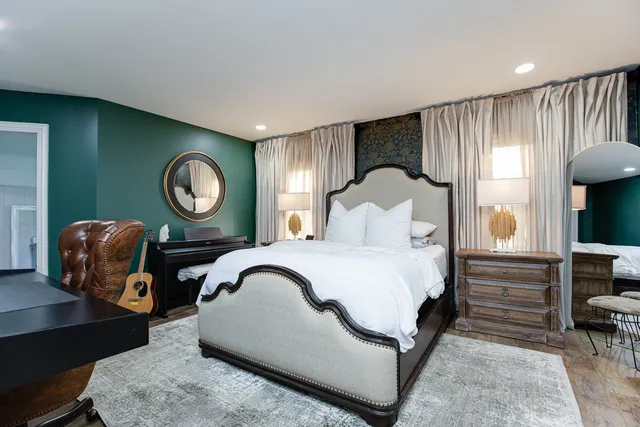 a bedroom with a bed lamp closet and window