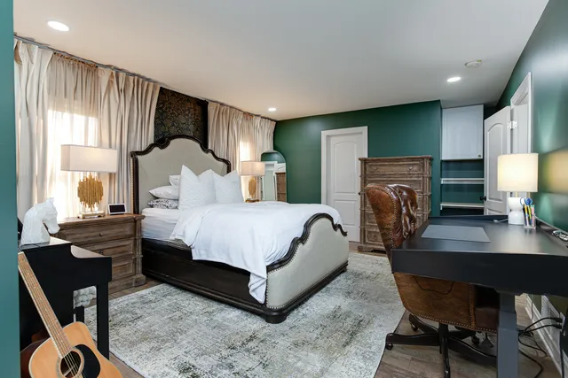 a bedroom with a bed a desk and chair