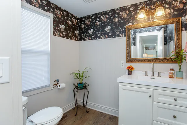 a bathroom with a toilet sink and mirror