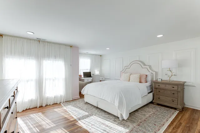 a bedroom with a large bed and a window