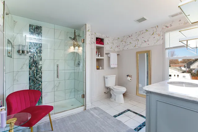 a bathroom with a toilet and a shower