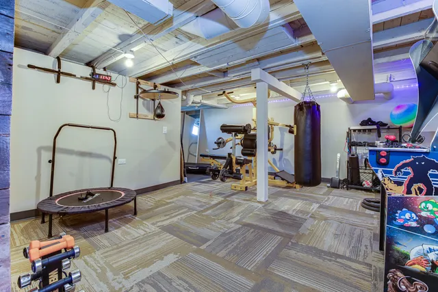 a view of a room with lots of gym equipment