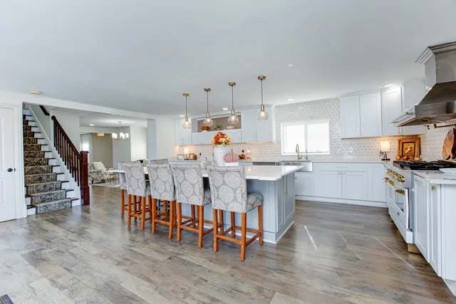 a large kitchen with lots of counter space and furniture