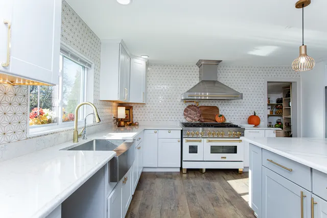 a kitchen with stainless steel appliances a stove a sink and a refrigerator