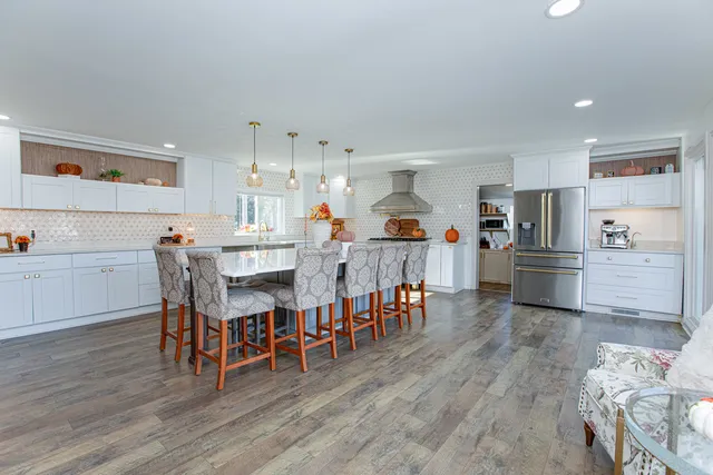 a large kitchen with a table and chairs