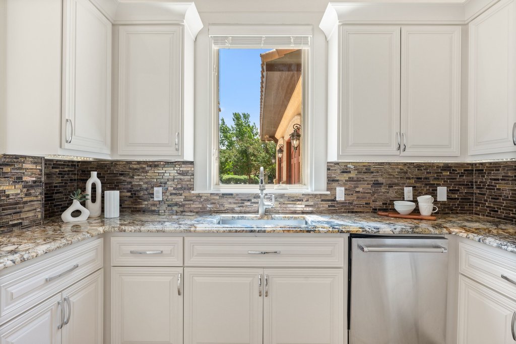 102 Long Point Cove Georgetown, TX 78628 - Photo 9 of 36 a kitchen with granite countertop white cabinets and a sink