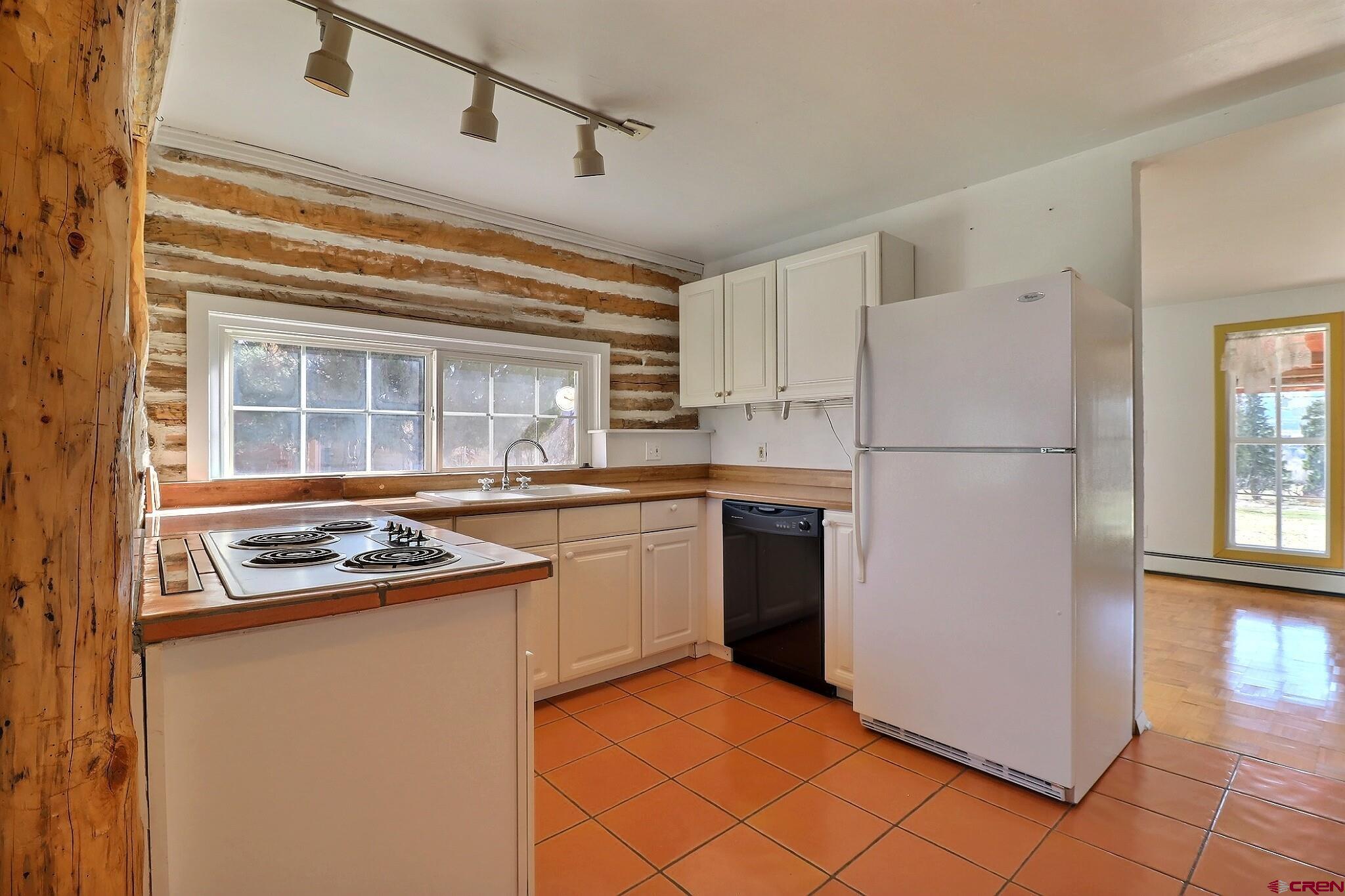 39599 Pitkin Road Paonia, CO 81428 - Photo 11 of 43 a kitchen with a refrigerator a stove top oven and cabinets