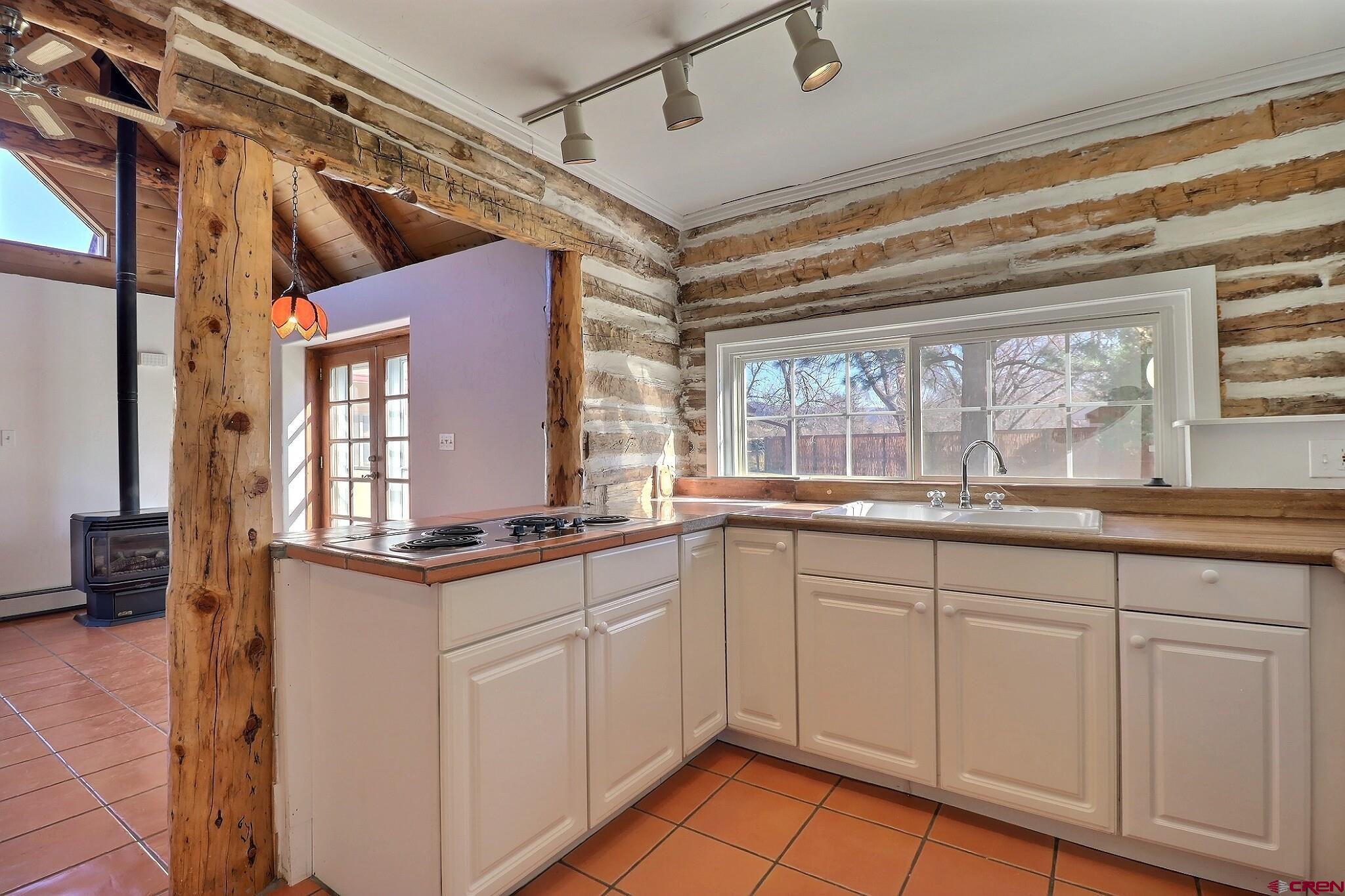 39599 Pitkin Road Paonia, CO 81428 - Photo 12 of 43 a kitchen with granite countertop white cabinets and white appliances