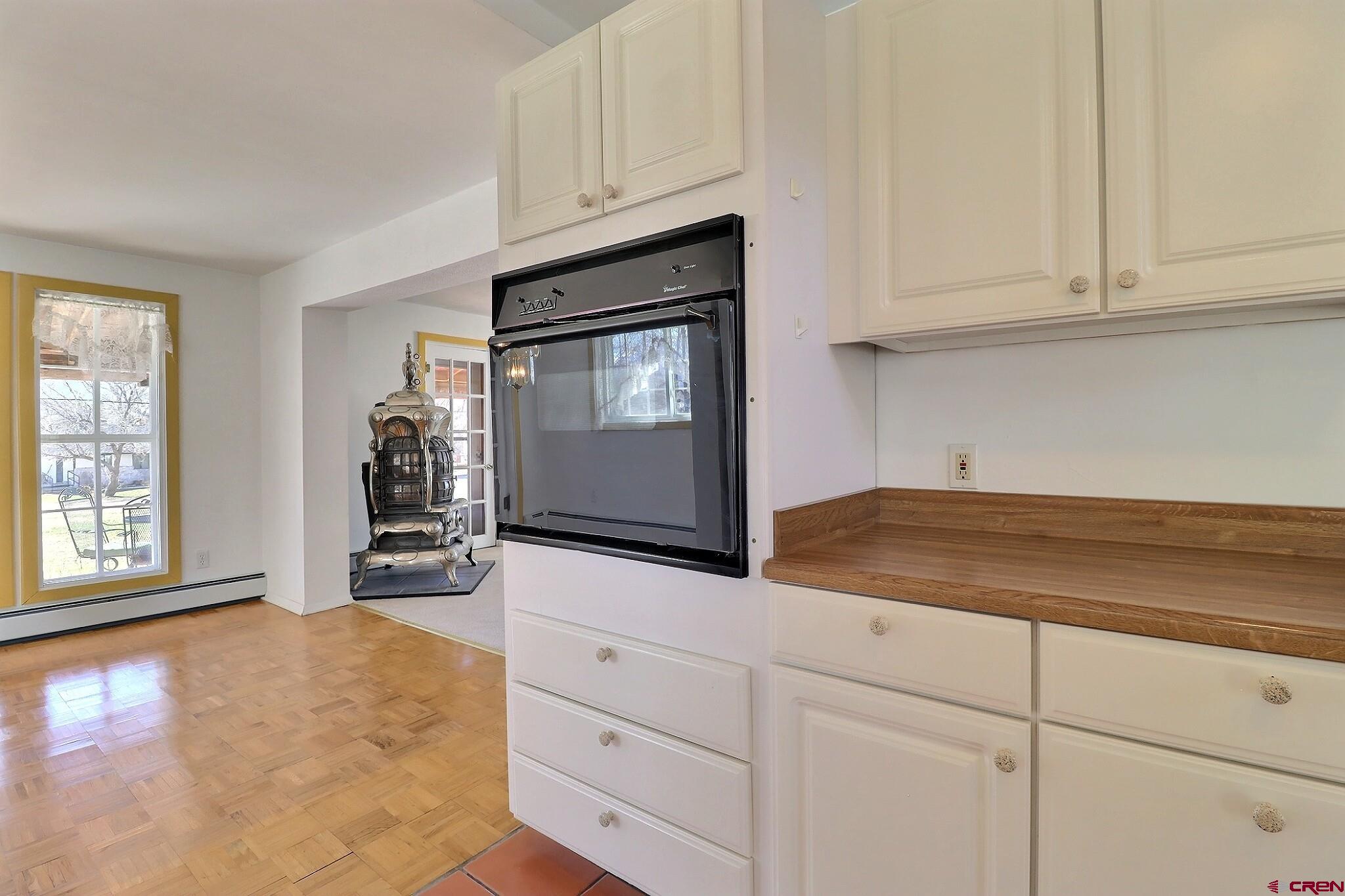 39599 Pitkin Road Paonia, CO 81428 - Photo 14 of 43 a kitchen with granite countertop white cabinets and window