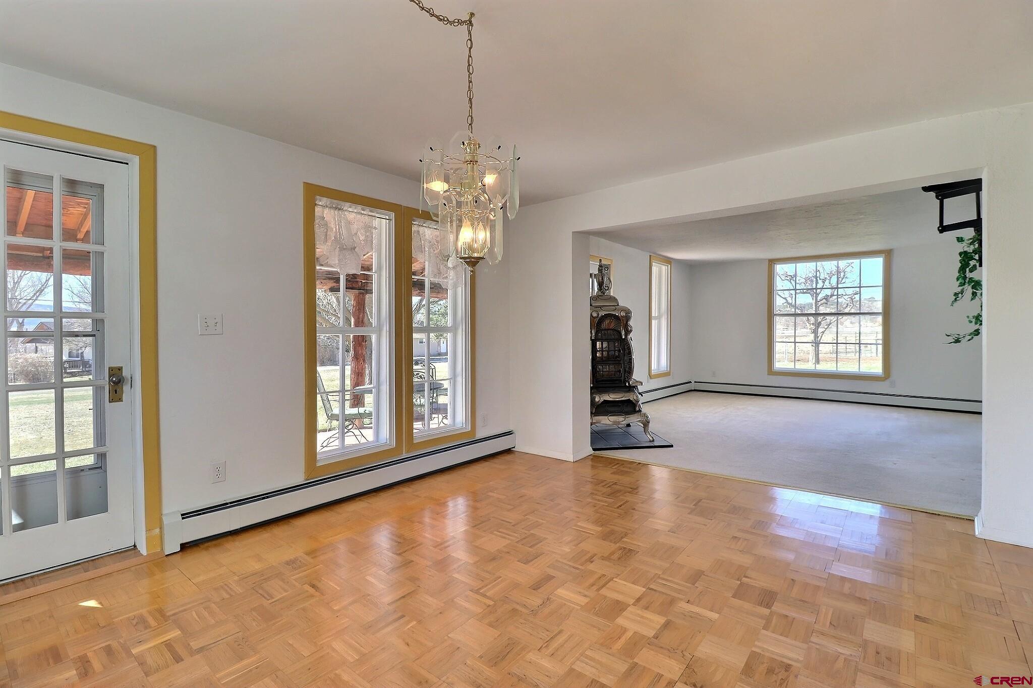 39599 Pitkin Road Paonia, CO 81428 - Photo 16 of 43 a view of an empty room with a window and wooden floor