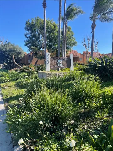 a view of a garden with a building in the background