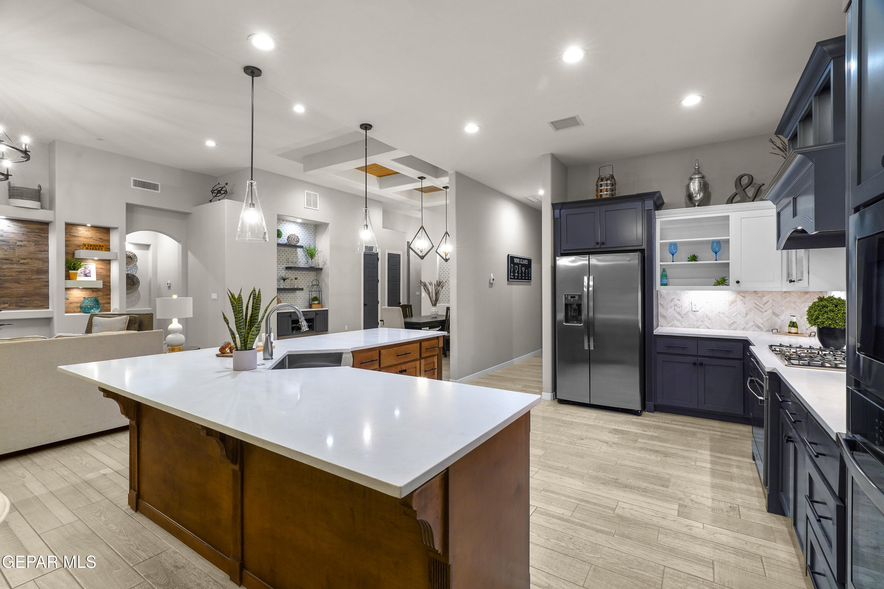 320 Emerald Rise Drive El Paso, TX 79928 - Photo 11 of 29 a kitchen with stainless steel appliances kitchen island granite countertop a refrigerator a sink dishwasher and a stove with wooden floor