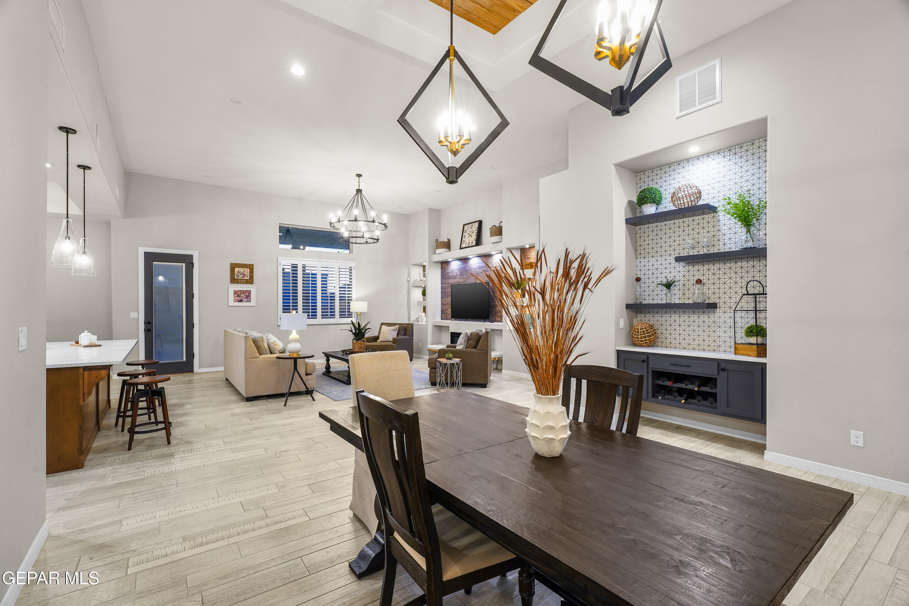 320 Emerald Rise Drive El Paso, TX 79928 - Photo 5 of 29 a dining room with wooden floor a chandelier a wooden table and chairs