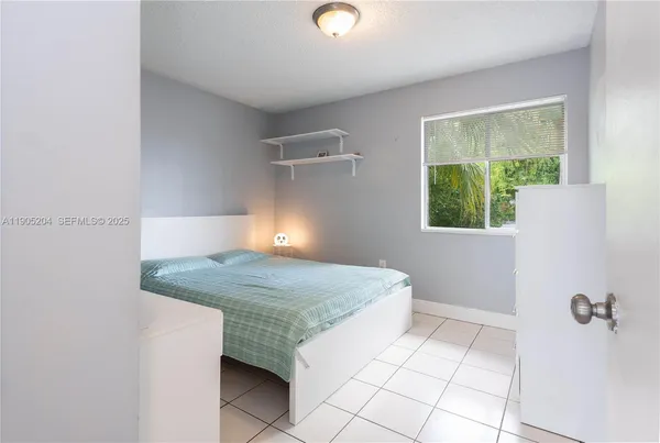 a bedroom with a bed and a lamp