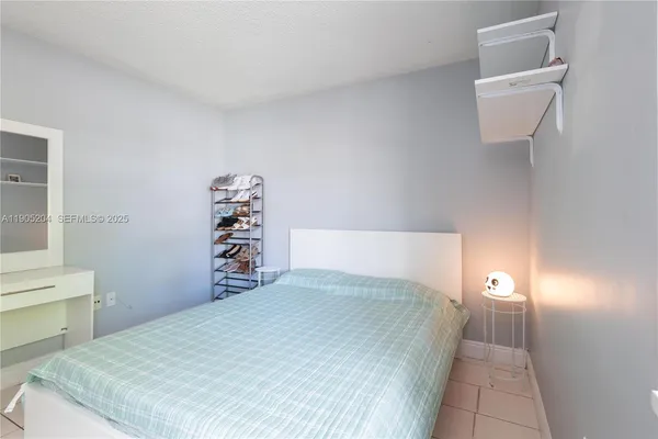 an empty room with window and cabinet