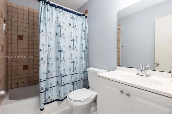 a living room with furniture a dining table and a chandelier