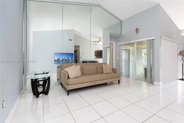 a living room with furniture and a lamp