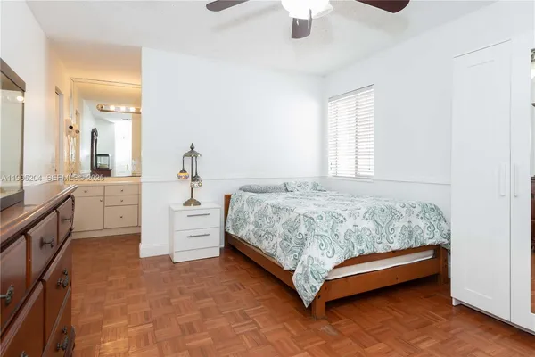a bedroom with a bed and ceiling fan