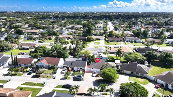 an aerial view of residential houses with outdoor space