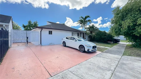 a view of a house with sitting area and garden
