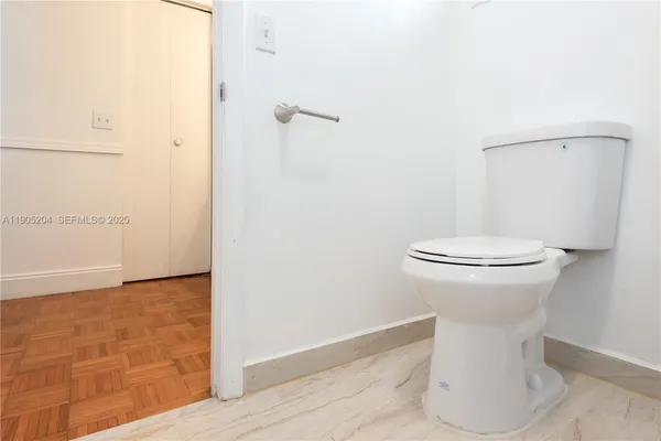 a white toilet sitting next to a white sink